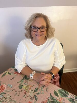 Kim Bost, founder of Lake Tillery Mahjong Loft, seated at a mahjong table